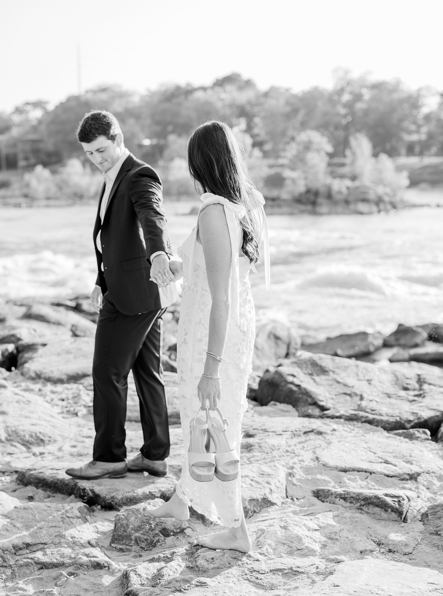couple walking along Chattahoochee Riverwalk for their engagement session photography